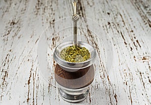 Traditional Argentinian yerba mate tea in a calabash gourd with bombilla stick.