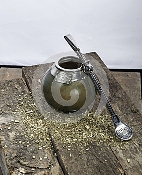 Traditional Argentinian yerba mate tea on top of an old wooden planks