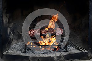 Traditional asado grilling in an ancient, rustic fireplace photo