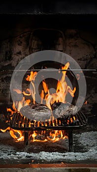 Traditional asado grilling in an ancient, rustic fireplace photo