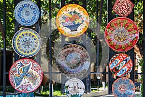 traditional Asian Arab Uzbek ceramic plates hand-painted in street in Uzbekistan