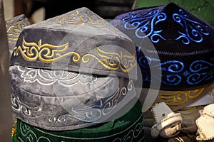 Traditional Asian headdresses from a multicolored felt with an embroidered colored thread of national ornament