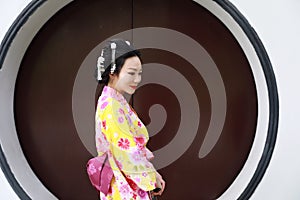 Traditional Asian Japanese beautiful Geisha woman wears kimono in a summer nature