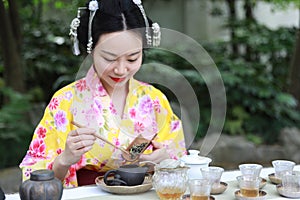 Traditional Asian Japanese beautiful woman conduct tea ceremony in outdoor garden