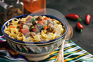 Traditional asian noodle soup with vegetables and meat, known as lagman. Oriental, uzbek style cuisine. photo