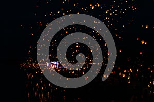 Traditional asian paper flying lights in sky festival