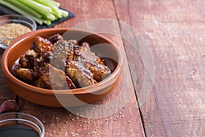 Traditional Asian stir fry chicken wings with sesame and vegetables