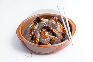 Traditional Asian stir fry chicken wings with sesame and vegetables