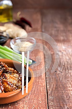 Traditional Asian stir fry chicken wings with sesame and vegetables. Copy