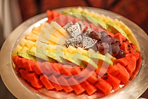 Traditional Asian tropical fruits selection; Grape, Watermelon, Guava, Dragon Fruit, Papaya, Pineapple with hand craft carving in