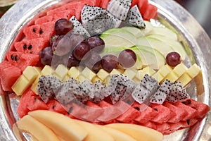 Traditional Asian tropical fruits selection; Grape, Watermelon, Guava, Dragon Fruit, Papaya, Pineapple with hand craft carving in
