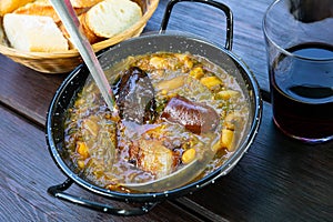 Traditional Asturian rich stew with cabbage, potatoes, beans and compango photo