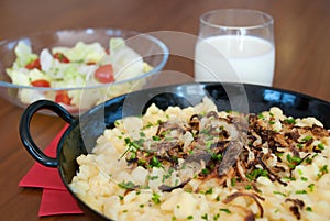 Traditional austrian spaetzle with melted cheese in pan - kÃÂ¤sespÃÂ¤tzle kasnocken