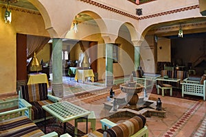 Traditional authentic Moroccan riad interior with sitting and dining area