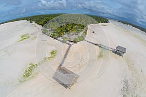 Traditional authentic overwater thatched roof bungalow of native local aborigines Micronesian people in atoll lagoon. Kiribati. photo