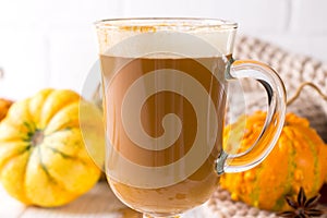 Traditional autumn dishes. Halloween, Thanksgiving. Mug of hot and spicy aromatic pumpkin latte with whipped cream on top.