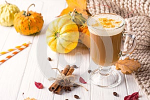Traditional autumn dishes. Halloween, Thanksgiving. Mug of hot and spicy aromatic pumpkin latte with whipped cream on top.