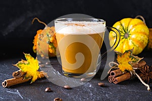 Traditional autumn dishes. Halloween, Thanksgiving. Mug of hot and spicy aromatic pumpkin latte with whipped cream on top.