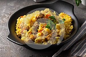 Traditional azian pilaf served in plate on gray background