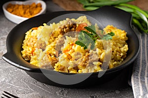 Traditional azian pilaf served in plate on gray background