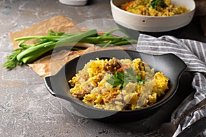 Traditional azian pilaf served in plate on gray background