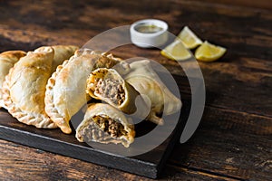 Traditional baked Argentine empanadas savoury pastries with beef stuffing. photo