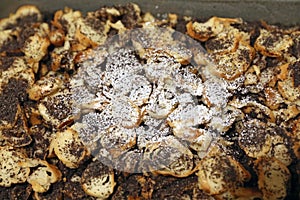 Traditional baked polish and hungarian dessert makowki made of  sliced croissant and poppy seeds with honey