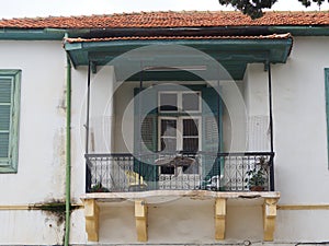 Traditional balcony in old residential house in Larnaka with columns and blue frame