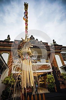Traditional Bali Penjor, bamboo pole with decoration on Balinese people house in Bali photo