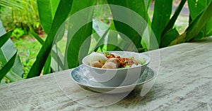 Traditional balinese food. Plate with tasty dish of indonesian national Meatball Chicken Noodles soup or mie bakso ayam