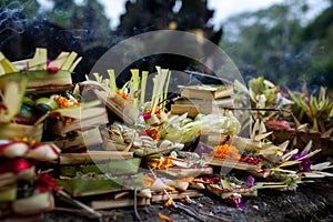 Traditional balinese offerings to gods in Bali with flowers and aromatic sticks.Bali, Indonesia, Tirta Empul temple