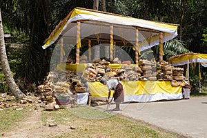 Indonesia Bali Traditional balinese offerings to Gods burned temple in Ubud Men cleaning