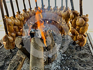 A traditional Balochi chicken Sajji is made in an open fire in Pakistan