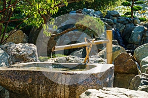 Traditional Bamboo Fountain in Japanese garden. Public landscape park of Krasnodar or Galitsky park