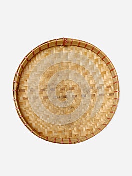 a traditional bamboo tray used to winnow rice and to put snacks commonly called cake tampah