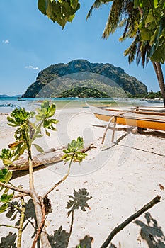 Traditional banca boat on sandy Corong Corong Beach in El Nido, Philippines