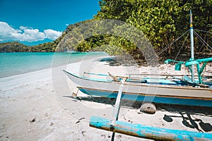 Traditional banca fishermen boat on sandy remote tropical beach. El Nido, Philippines