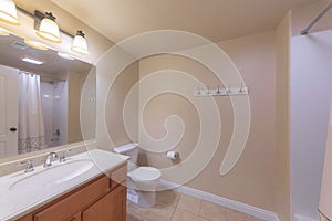 Traditional bathroom interior with beige wall and white baseboard