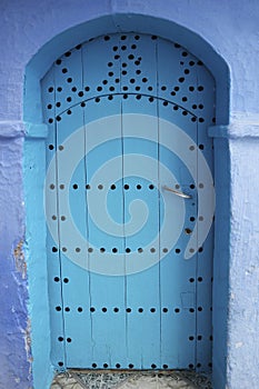 Traditional beautiful door in blue city of Chefchaouen, Morocco. Typical moroccan architecture.