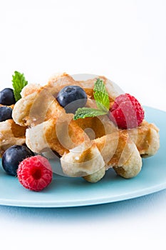 Traditional belgian waffles with blueberries and raspberries, isolated