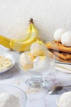 Traditional Belgian waffles with fruit ice-cream on gray plate. Banana taste. Sweet breakfest