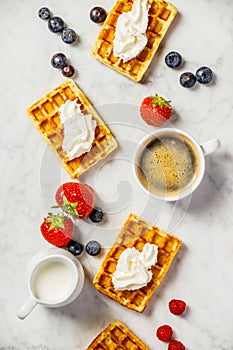 Traditional belgian waffles with whipped cream and fresh fruits