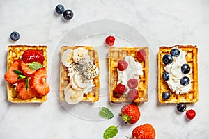 Traditional belgian waffles with whipped cream and fresh fruits