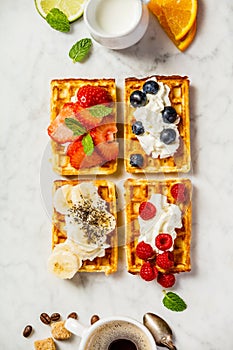 Traditional belgian waffles with whipped cream and fresh fruits