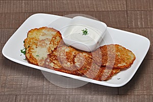 Traditional belorussian potato pancakes with machanka sauce