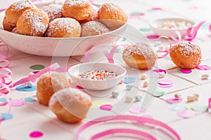 Traditional Berliner for carnival and party. German Krapfen or donuts with streamers and confetti