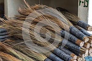 Traditional Bhutanese brooms on a pile