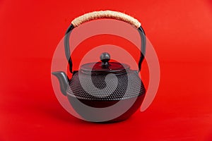 Traditional black asian cast iron kettle or teapot isolated on white background