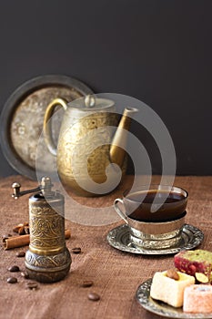 Traditional black coffee in vintage cup, retro mill and beans. Turkish delights oriental sweet dessert