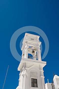 Traditional blue dome church and white bell tower in Santorini in Greece